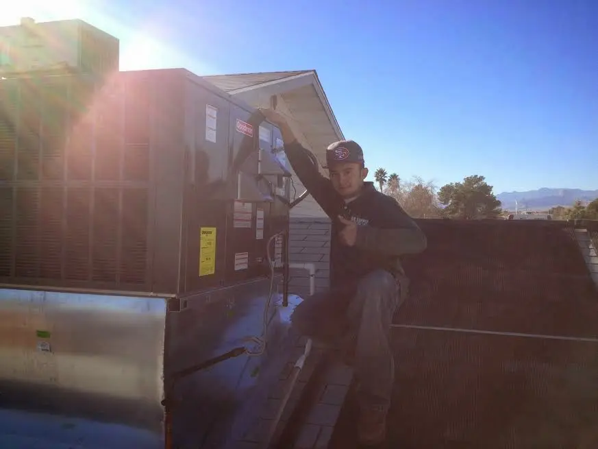 HVAC technician performing HVAC Inspection on a rooftop unit in Bluefield